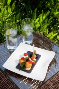 a plate of food on a table with two glasses of water at Yalbury Cottage in Dorchester