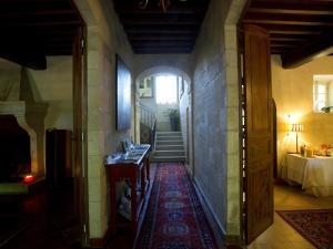 a hallway of a house with a table and a staircase at Domaine de Rhodes B&B in Avignon