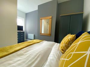 ein Schlafzimmer mit einem großen Bett und einem Spiegel in der Unterkunft Mayfair Suite Sasco Apartments in Blackpool