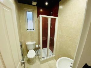 a small bathroom with a toilet and a shower at Callerton House in Newcastle upon Tyne