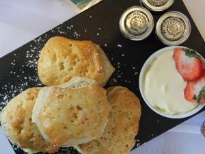 a plate with biscuits and a bowl of yogurt and strawberries at The WatersEdge, Canal Cottages in Hillingdon