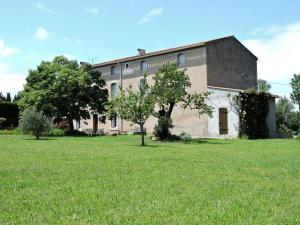 a large building with a green field in front of it at Domaine Saint-Louis in Carcassonne