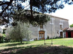 a building with a swing in front of it at Domaine Saint-Louis in Carcassonne