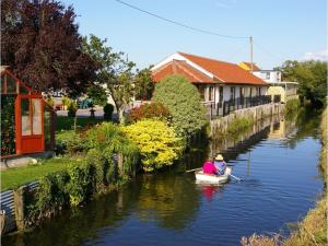 two people are in a boat on a river at Double-Gate Farm in Wells