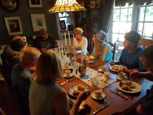 a group of people sitting around a table eating food at Dragonfly Bed and Breakfast in Antioch