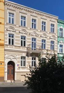 a large building with a door and a balcony at ZEYER APARMENTS in Teplice