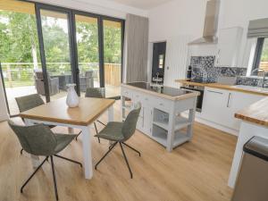 a kitchen with a table and chairs and a table at The Barn in Redditch +19 photos