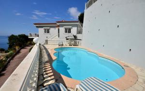 a swimming pool on the side of a building at Villa piscine Eze bord de mer à 500m de la plage in Èze