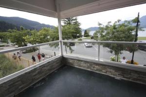 a room with a view of a street from a building at Harrison Spa Motel in Harrison Hot Springs