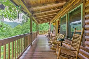 a porch of a cabin with chairs and tables at Mountain-View Maggie Valley Home with 2 Decks! in Waynesville