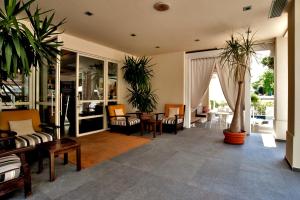 a living room with potted plants and a table at Le Rose Spa Hotel in Rimini