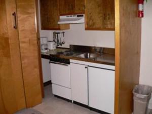 a small kitchen with a sink and a stove at Evergreen Valley Inn in North Lovell