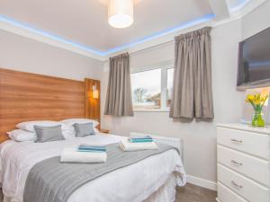 a bedroom with a bed with two towels on it at Fab Apartment in Loughborough