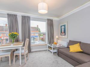 a living room with a couch and a table at Fab Apartment in Loughborough