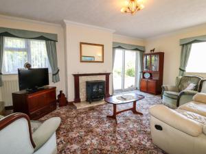 a living room with a couch and a fireplace at Summerfields in Uttoxeter