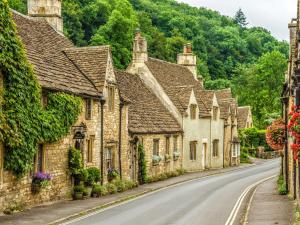 a row of stone houses on a street in a village at Fire Service College in Moreton in Marsh