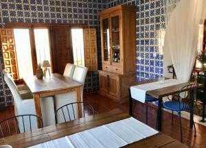 a dining room with two tables and chairs and blue walls at Villa FenaVista in Mijas