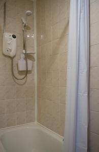 a shower with a white shower curtain in a bathroom at Carvetii - Fox House - 1st floor flat sleeps up to 8 in Dunfermline