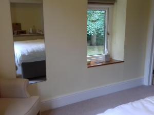 A bed or beds in a room at Foxlow Coach House