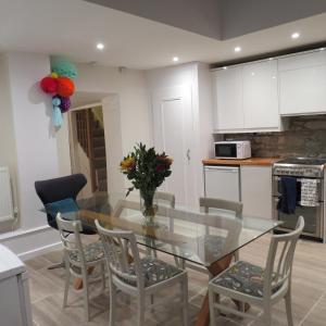 a kitchen with a glass dining room table and chairs at Frog Palace - Secure Parking-Outside Area-Topsham-Exeter-Beach-Chiefs-WiFi in Topsham