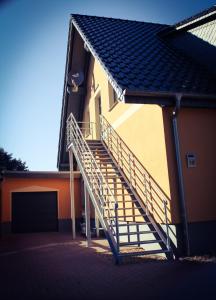 a metal staircase on the side of a building at Gästehaus Burgblick in Neustadt-Glewe