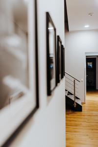 a hallway with a row of framed pictures on a wall at Gerberhof in Erfurt