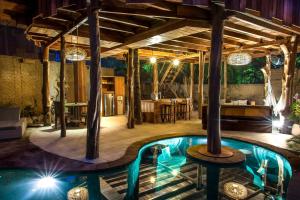 a pool in the middle of a room with a table at Gili Treehouses Private Pool Hideaway in Gili Trawangan