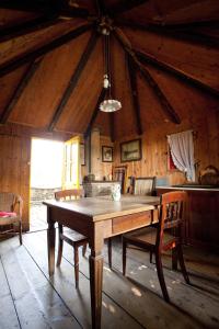 a dining room with a wooden table and chairs at Agriturismo Santa Maria Bressanoro in Castelleone