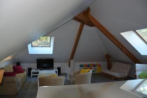 an attic living room with a roof at Champagne BNB - La Source in Fontaine-sur-Ay