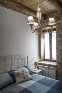 a bedroom with a blue bed and a window at B&B Antico Casale in Fuscaldo