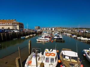 a bunch of boats are docked in a harbor at The George in West Bay +41 photos