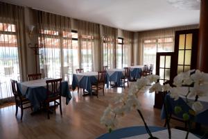 a room with tables and chairs with blue and white tables at Hotel B&B Fortuna in Costermano