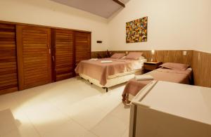 Una cama o camas en una habitación de Pousada Brésil Aventure