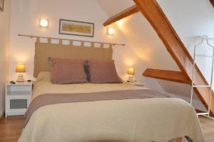 a bedroom with a large bed with two lamps at Gite Ty-Coz in Charly-sur-Marne