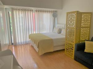 a bedroom with a large bed and a chair at Almada Story Apartments by Porto City Hosts in Porto