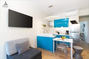 a kitchen with a blue and white kitchen with a couch at Avra Maris in Sitia