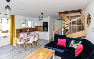 a living room with a couch and a table at Apartament Twoja Przystań in Jantar