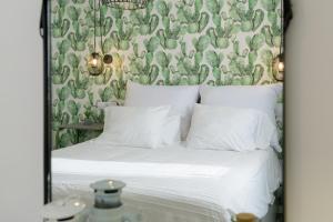 a bedroom with a bed with a green and white wallpaper at Buenavista Ocean View in Puerto del Carmen +35 photos