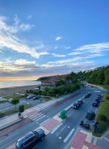 a street with cars parked on the side of the road at Petit Palace Tamarises in Getxo