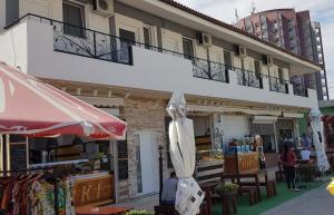 a building with an umbrella and a table and chairs at Vila Marea Venusului in Venus