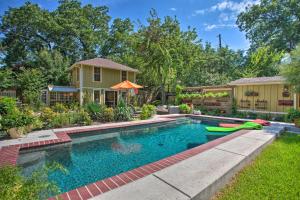 a swimming pool in a yard with a house at The Quarters at Fairmount Cottage with Shared Pool in Fort Worth