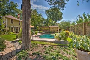 a backyard with a pool and a tree at 4 Mi to Dtwn! Fort Worth Cottage w/ Shared Pool in Fort Worth