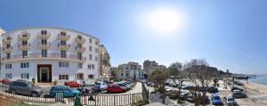 a group of cars parked in a parking lot next to a building at City Marina in Corfu