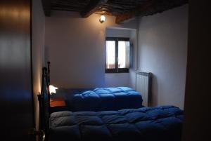 a bedroom with a bed and a window at Le case all'arco in Castropignano