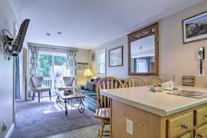 a kitchen and living room with a couch and a table at Lake Getaway Walk Across Street to Private Beach! in Gilford