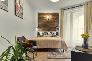 a bedroom with a bed and a wooden wall at Sherlock Apartment in Wrocław