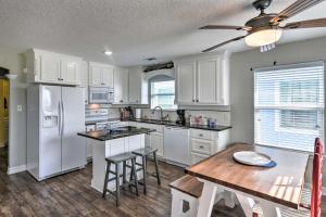 eine Küche mit weißen Geräten und einem Holztisch in der Unterkunft Luxe Surfside Beach Family Home 2 Blocks to Ocean in Surfside Beach