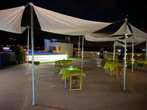 a patio area with tables, chairs and umbrellas at Hotel Fonda Neus in Sant Sadurní dʼAnoia