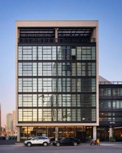 a large building with cars parked in front of it at The Emily Hotel in Chicago