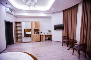 a hotel room with a bed and a mirror at Hotel Ak Saray in Tashkent +34 photos